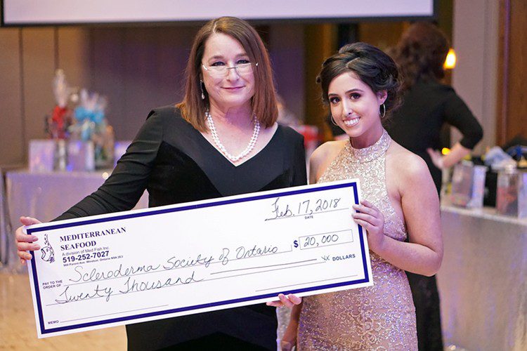 Rebecca presenting a cheque at the 2018 Scleroderma Society Benefit Gala.